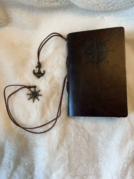 travel gifts for dad A black journal with a compass