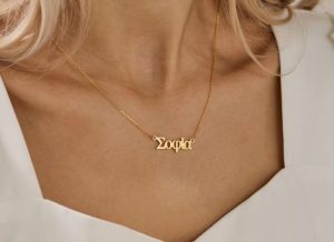 greek gift ideas A woman wearing a necklace with a name written in Greek letters