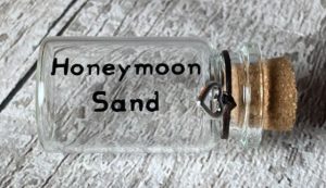 wedding gifts for travelers An empty bottle with the text "honeymoon sand"