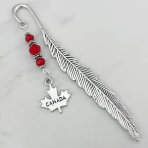 A bookmark with a pendant of a maple leave with "Canada" engraved