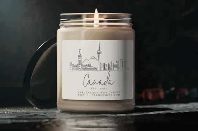 A soy candle with a label of "Canada" and the skyline of Toronto