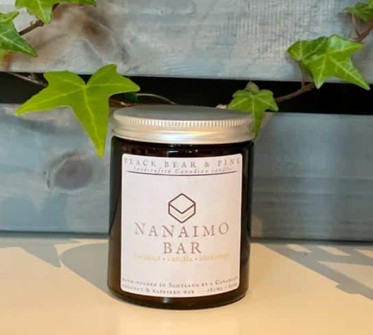 A candle with a label of a typical Canadian food 'the nanaimo'
