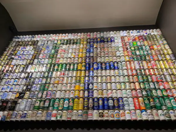 A wall made from beer cans and that spell the word "beer"