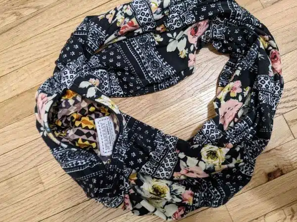 stocking stuffers for travelers An infinity scarf with a floral print and a hidden pocket