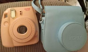 travel gifts for teenagers A pink poloroid with a bag
