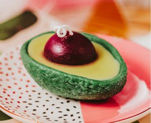 A candle that looks like an avocado