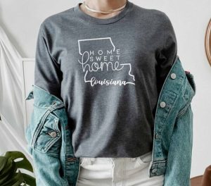 A woman wearing a sweat shirt with the map of Louisiana and "Home sweet Home"