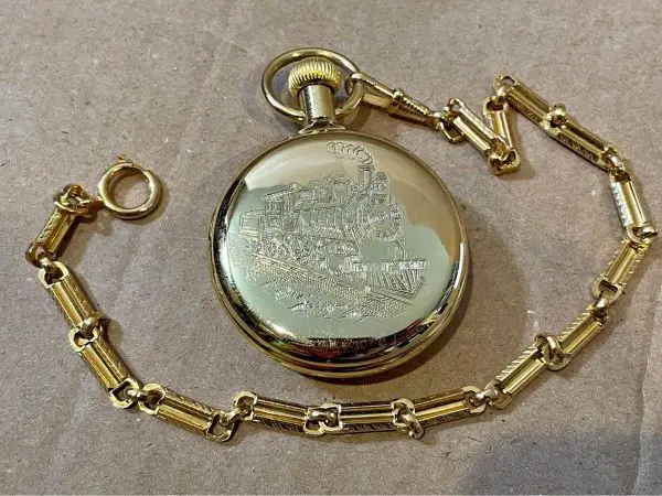 gifts for train lovers A pocket watch with an image of a train engraved
