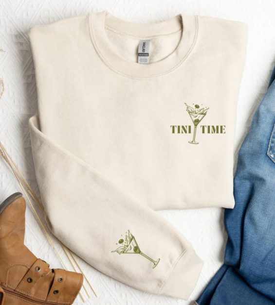 A white hoodie with embroidered martini glass and tini time