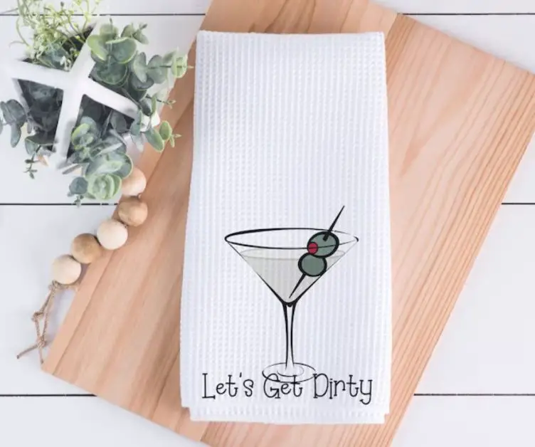 A white tea towel with "Let's get dirty"