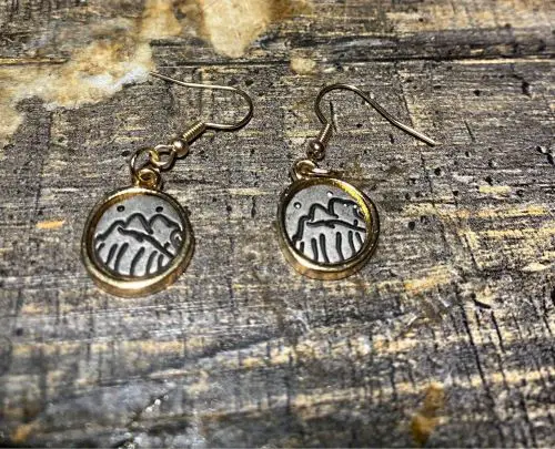 gifts for a daughter traveling abroad A pair or dangling earrings with mountain icons