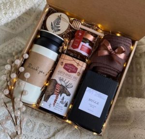 A Danish gift box with hygge items such as socks and candles