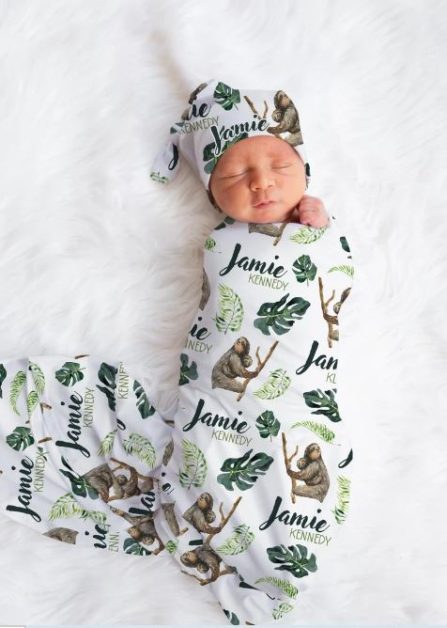 sloth gifts A baby wrapped in sloth-themed cloth