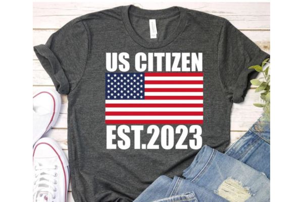 US citizenship gifts A grey t-short with the US flag and "US citizen est. 2023"