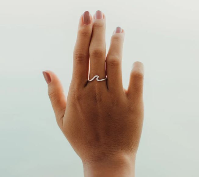 gifts for surfers A hand with a ring in the shape of a wave