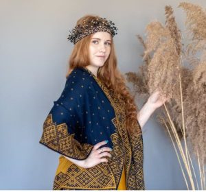 Latvian gifts A woman wearing a scarf with a traditional print from Latvia
