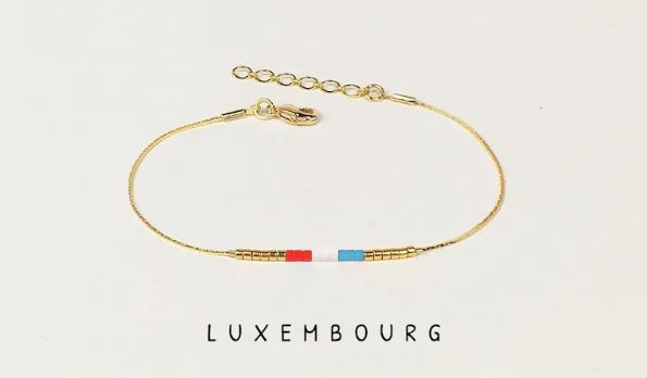 A golden bracelet with beads in the color of the flag of Luxembourg