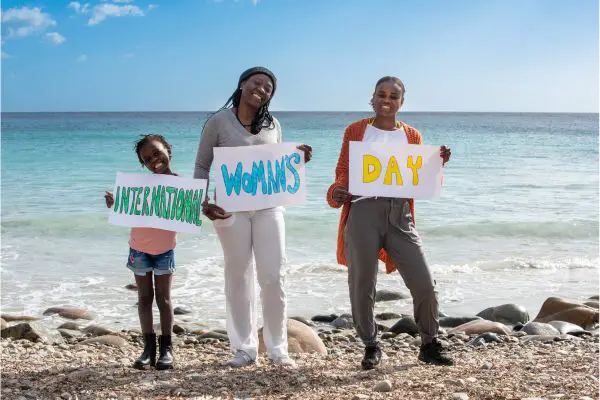 funny international Women's Day quotes Photo of three women holding signs saying "International Women's Day"