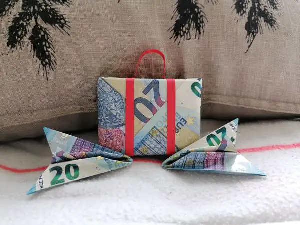 A suitcase and two airplanes origami from cash