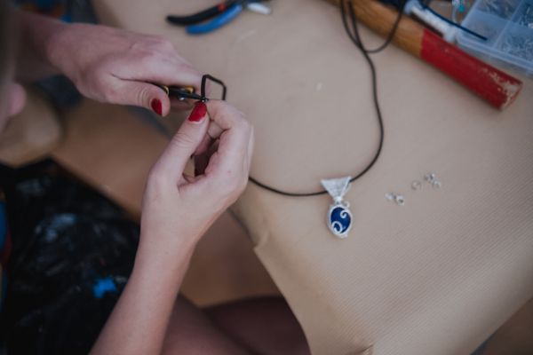 A woman making a necklace