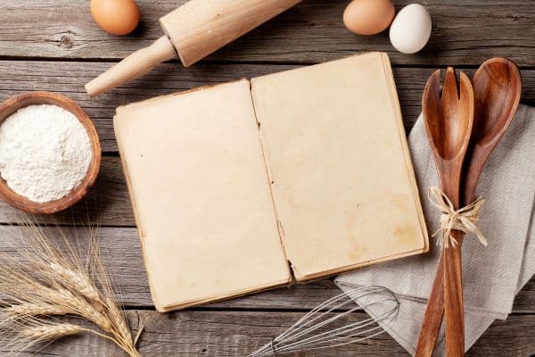 A notebook with cooking equipment layong around
