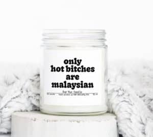 A wax candle with a label that reads "Only hot b*tches are Malaysian"