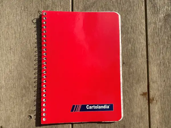 A red ring binder notebook