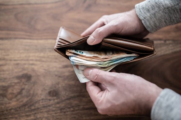 Someone showing cash in their wallet